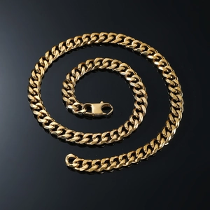 Detailed view of a polished gold Cuban link necklace with secure lobster clasp