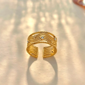 Detail view of multi-layer gold plated ring with sparkling crystals and textured finish