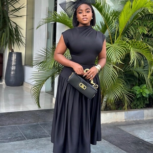 Chic black sleeveless pleated maxi skirt set with elegant handbag and headpiece accessory