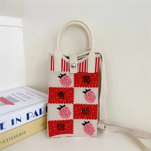 Detail of strawberry pattern checkered knit bag with adjustable strap and silver button