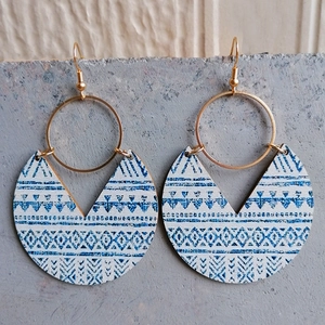 Bohemian blue printed geometric wood earrings with gold hardware on gray stone