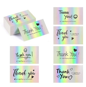 Macro detail of holographic thank you cards with vibrant rainbow laser finish for gifts