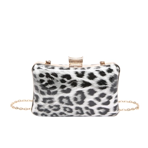 Detail shot of the black and white leopard print evening bag with sparkling diamond clasp