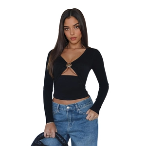 Detail of black long-sleeve crop top featuring a chest cutout with a metal O-ring accent