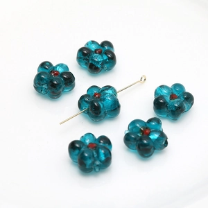 Detail of dark blue glass flower beads with brown center for DIY jewelry making