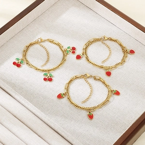 Double-layered gold titanium steel bracelet with red enamel cherry and strawberry charms