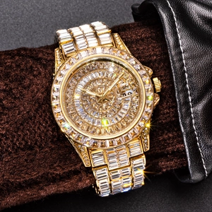 Close-up of gold iced-out quartz watch with square diamonds and calendar display