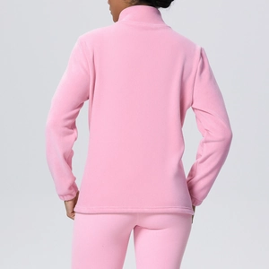 Detail view of pink fleece fabric texture on women's sports jacket and pants set