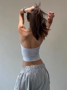 Detail of light blue halter top showing backless design and soft ribbed texture detail