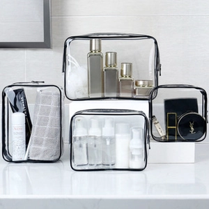 Set of four transparent PVC travel makeup bags with black zippers for organizing toiletries