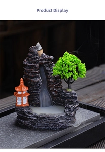 Detailed view of backflow incense burner with mountain landscape and tiny green trees