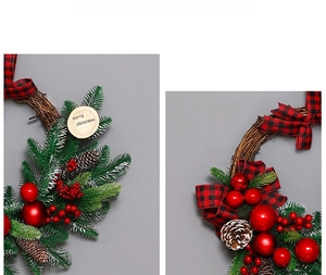 Detail of Christmas wreath with red berries, pine cones and Merry Christmas wooden sign