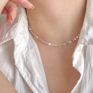 Minimalist 925 sterling silver disk choker necklace shown on neck with soft lighting