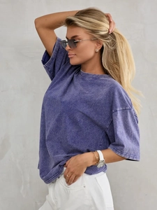 Detail of vintage acid wash texture on purple cotton t-shirt with loose drop shoulders