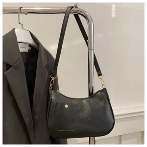 Close-up of black PU leather hobo bag with gold snap button pocket and sleek finish