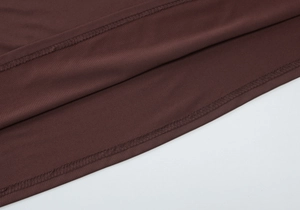 Close-up of the double-needle hem stitching on a brown stretch knit mini dress