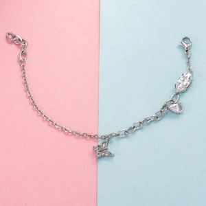 Detail of silver heart bracelet with sparkling butterfly charm and marquise zircon accents