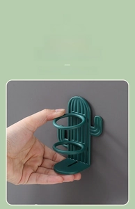 Detail of green cactus wall-mounted toothbrush holder with ventilated drainage base
