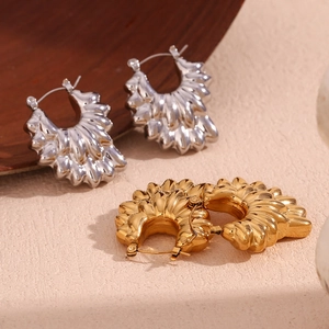 Detail of creative double-layer pleated petal hollow earrings in gold and silver finish