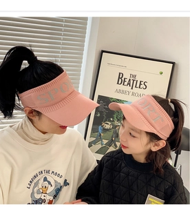 Close-up of pink knitted sports sun visor with SPORT embroidery for adults and kids