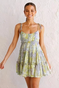 Detail of multi-layered floral tiered dress with spaghetti straps in light purple tones