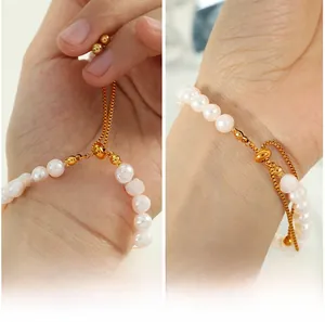Detail view of adjustable box chain with natural pearls and sliding gold bead clasp