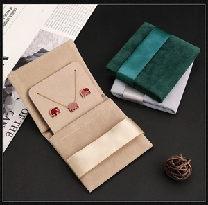 Detail of luxury velvet jewelry pouches in beige and grey with elegant silk ribbon ties