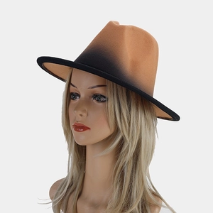Detail of a brown to black gradient wool fedora hat showing textured felt fabric and wide brim