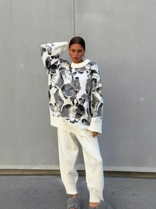Oversized white and grey rabbit jacquard knit sweater and pants set on a model