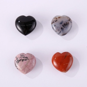 Polished heart-shaped natural crystals in black, grey, pink, and orange stone varieties