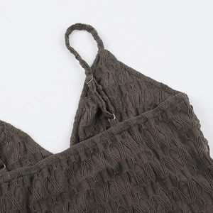 Macro shot of dark grey knitted tank top showing diamond jacquard texture and fine stitching