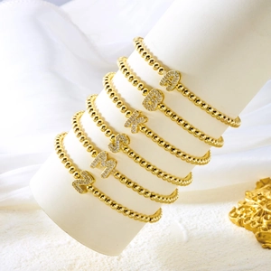 Golden bubble bead stretch bracelets featuring sparkling A-Z crystal letter pendants