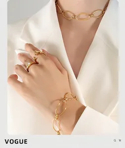 Close-up of gold chain jewelry set with oval links and pearl ring on professional model