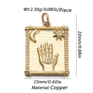 Macro view of gold Hamsa hand, crescent moon, and star pendant with zircon inlays