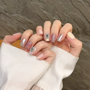Handmade aurora press-on nails with pink glitter, silver chrome finish and large rhinestones