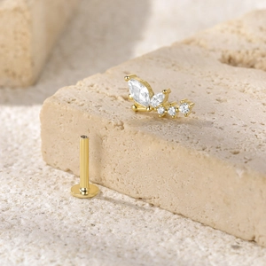 Macro view of gold S925 sterling silver butterfly labret stud with zircon stones on stone