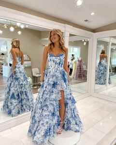 Three-way mirror view of strapless corset dress with blue floral print and high slit