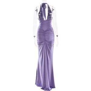 Detail showing the elegant backless halter neck design and pleated fabric of the purple dress