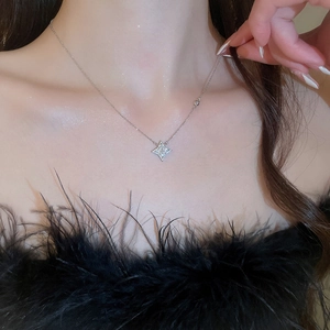 Close-up of sparkling silver star necklace with zircons on model's neckline