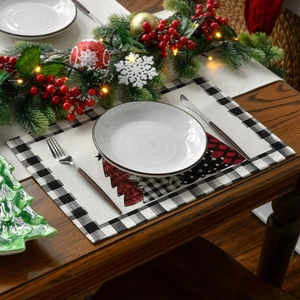 Christmas placemat with red reindeer on dark wood table with festive holiday decorations