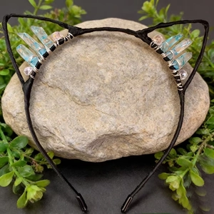 Detail of blue raw crystal cat ear headband with wire-wrapped stones on a rock