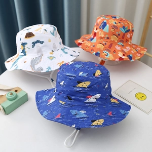Detailed view of children's sun hats with dinosaur and shark prints and windproof ropes
