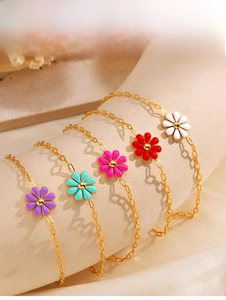 Detail of colorful daisy flower pendants on gold stainless steel bracelets for women