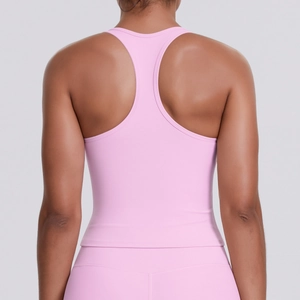 Close-up of racerback design on pink moisture-wicking athletic top and yoga set