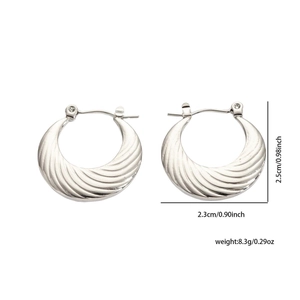 Detail view of silver stainless steel earrings with crescent texture and dimensions