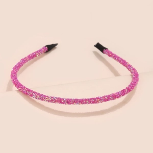 Detail of pink glitter headband with fine sequins and black protective rubber ends