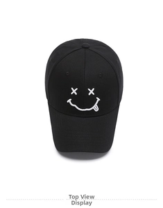 Top view of a black cotton baseball cap showing detailed white embroidered smiley face