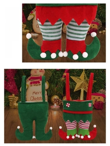 Close-up of festive Christmas elf pants candy bags with soft plush fabric and pom-poms