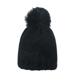 Black knitted winter beanie featuring a large faux fur pompom and a matching bow decoration