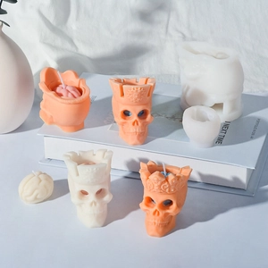 Skull scented candle silicone molds with crown and brain details on white fabric